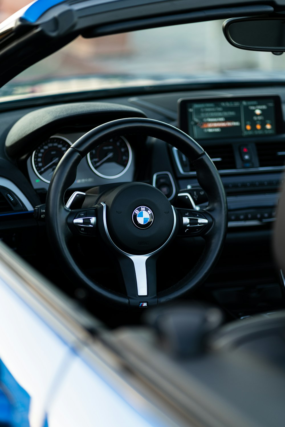 the interior of a car with a steering wheel and dashboard