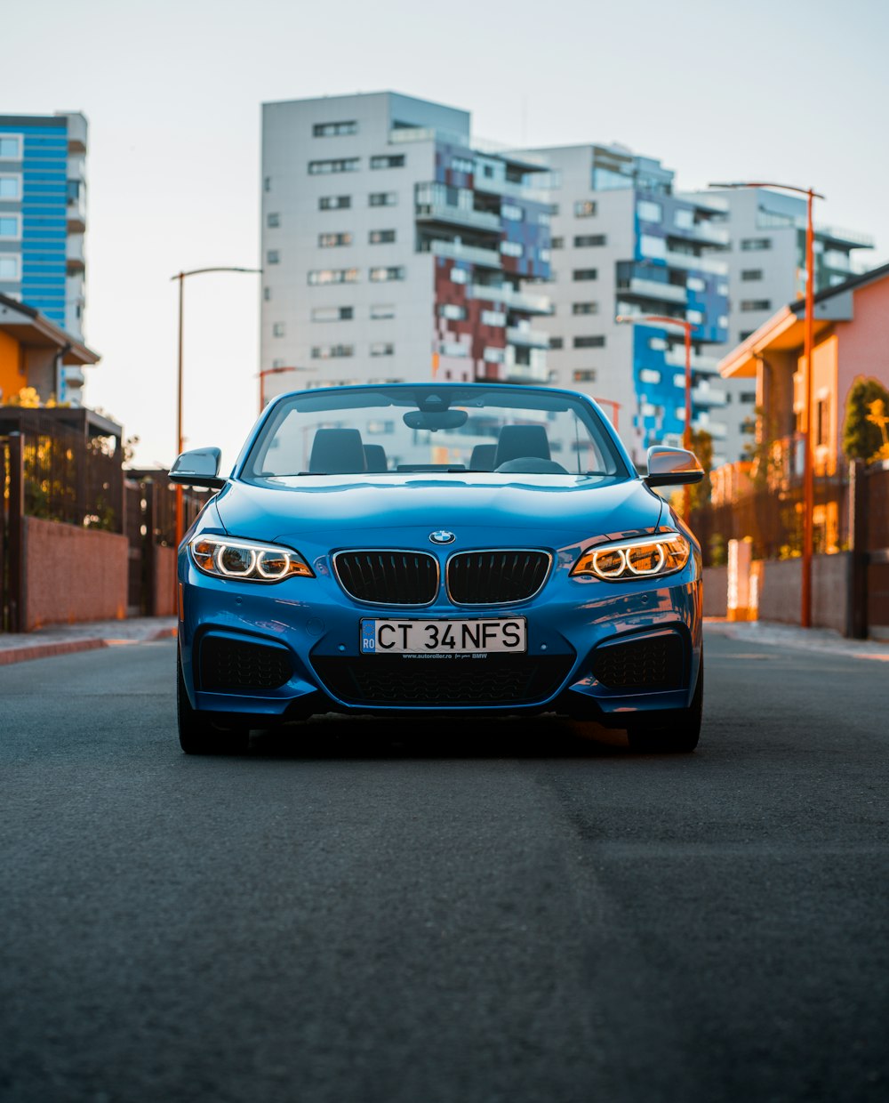 a blue car parked on the side of the road