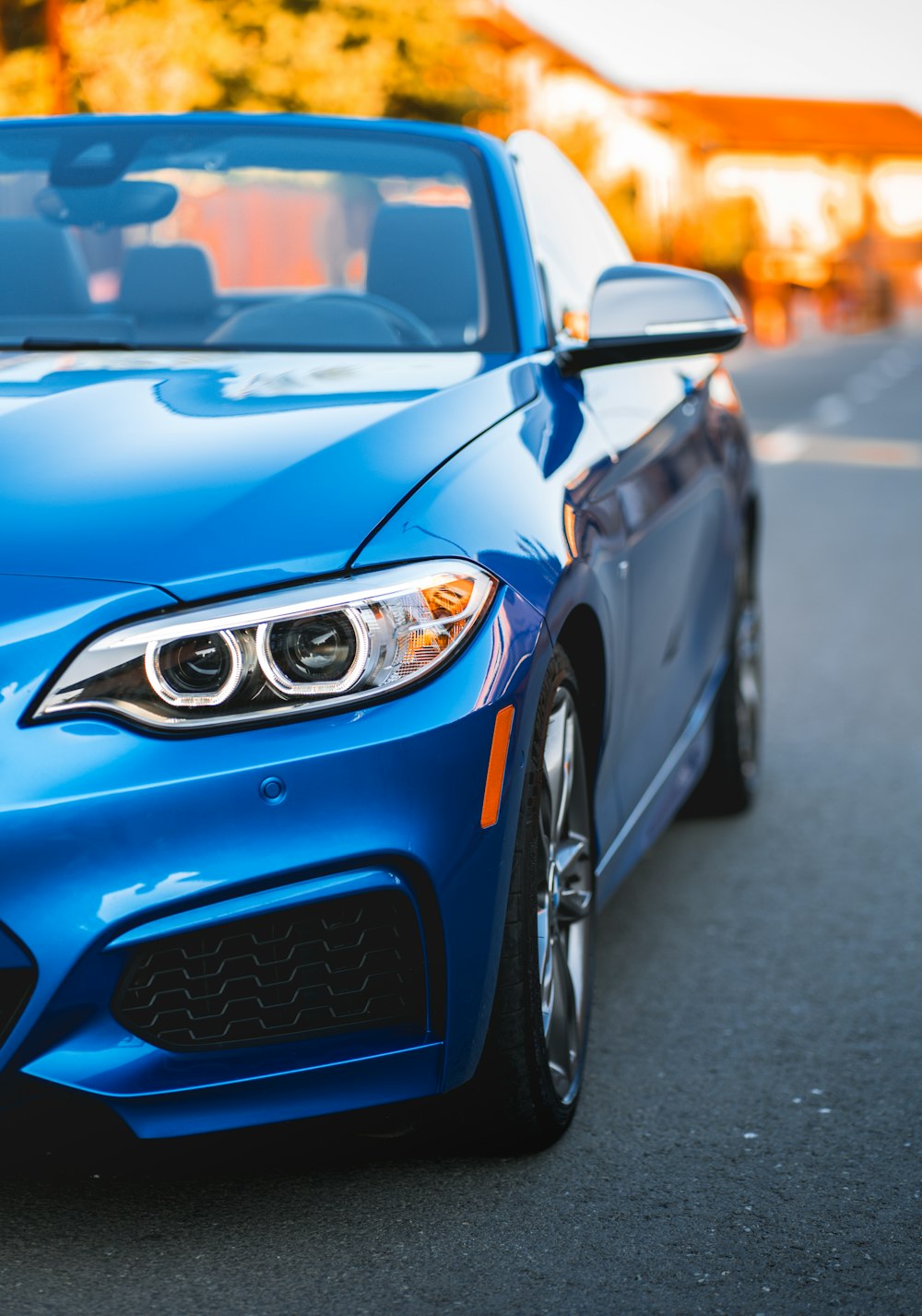 a blue car parked on the side of the road