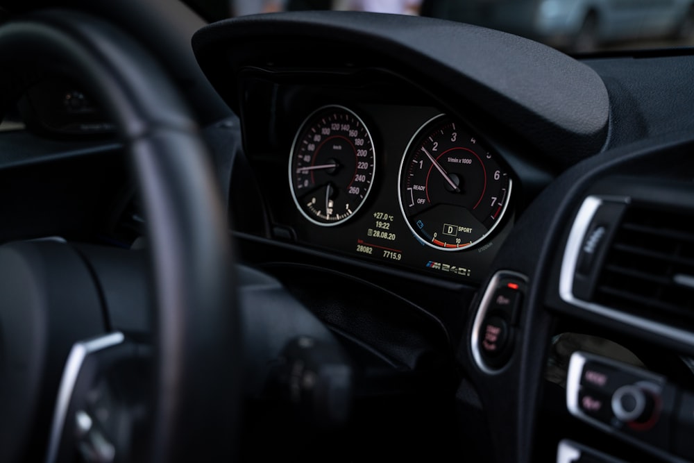 the dashboard of a car with a speedometer and gauges