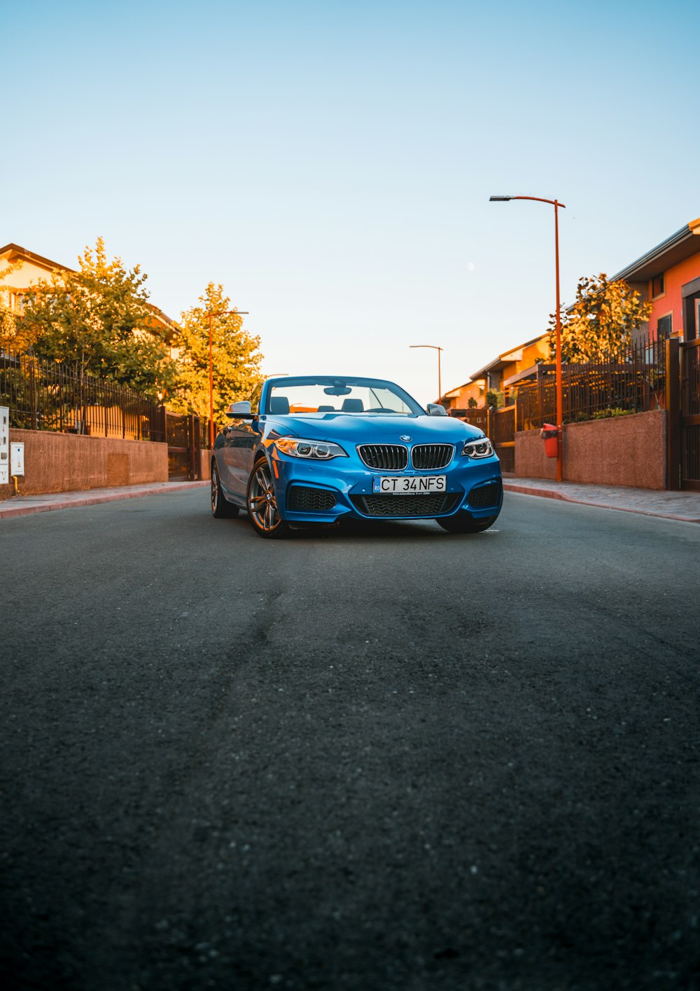 a blue car parked on the side of a road