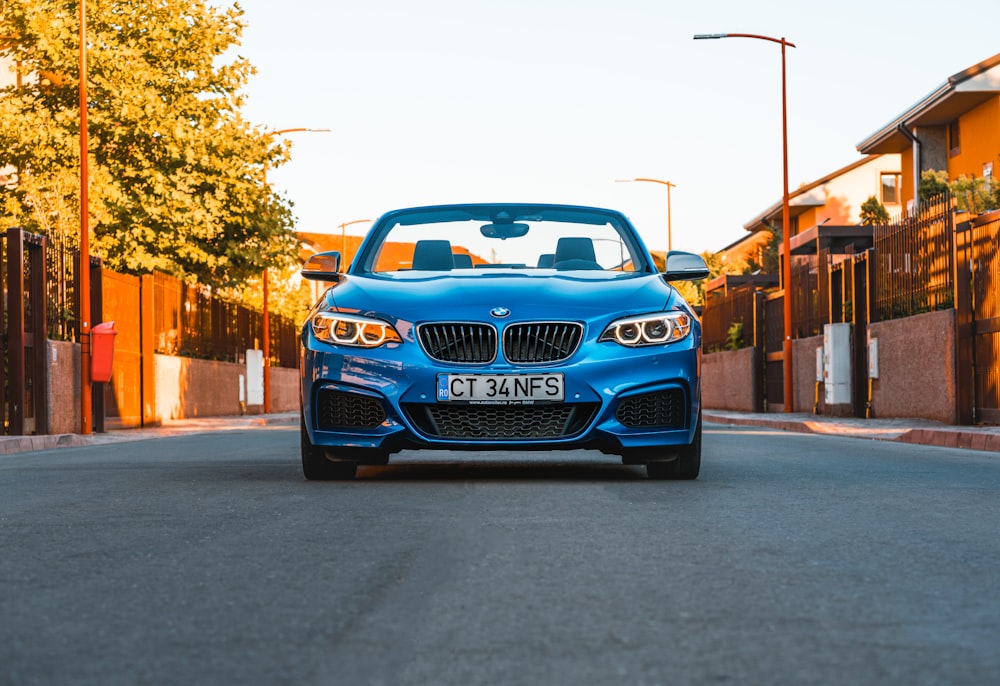 a blue car parked on the side of the road