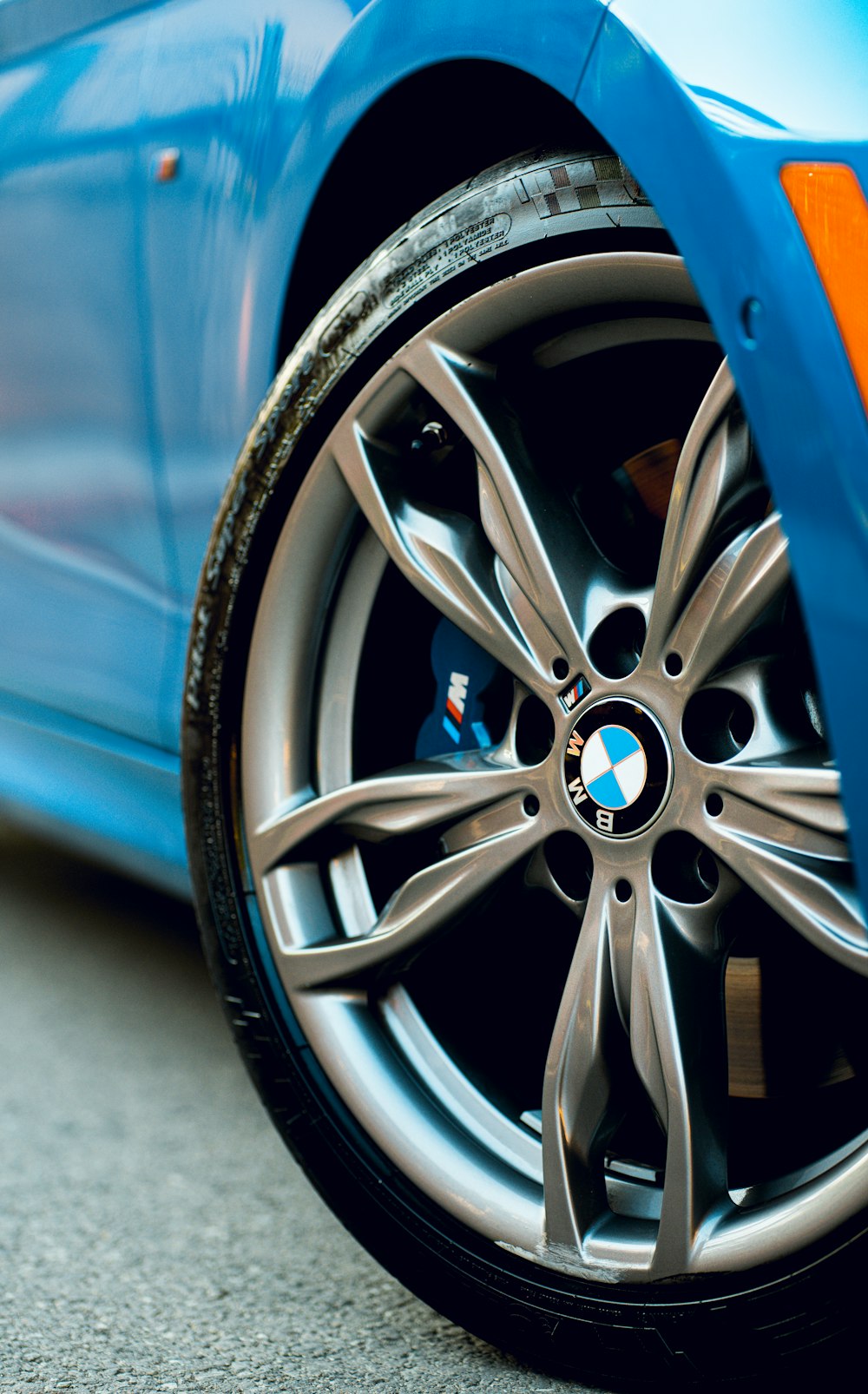 a close up of a blue bmw car tire