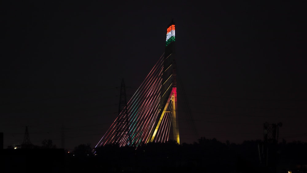 a very tall building with a very colorful light on it's side