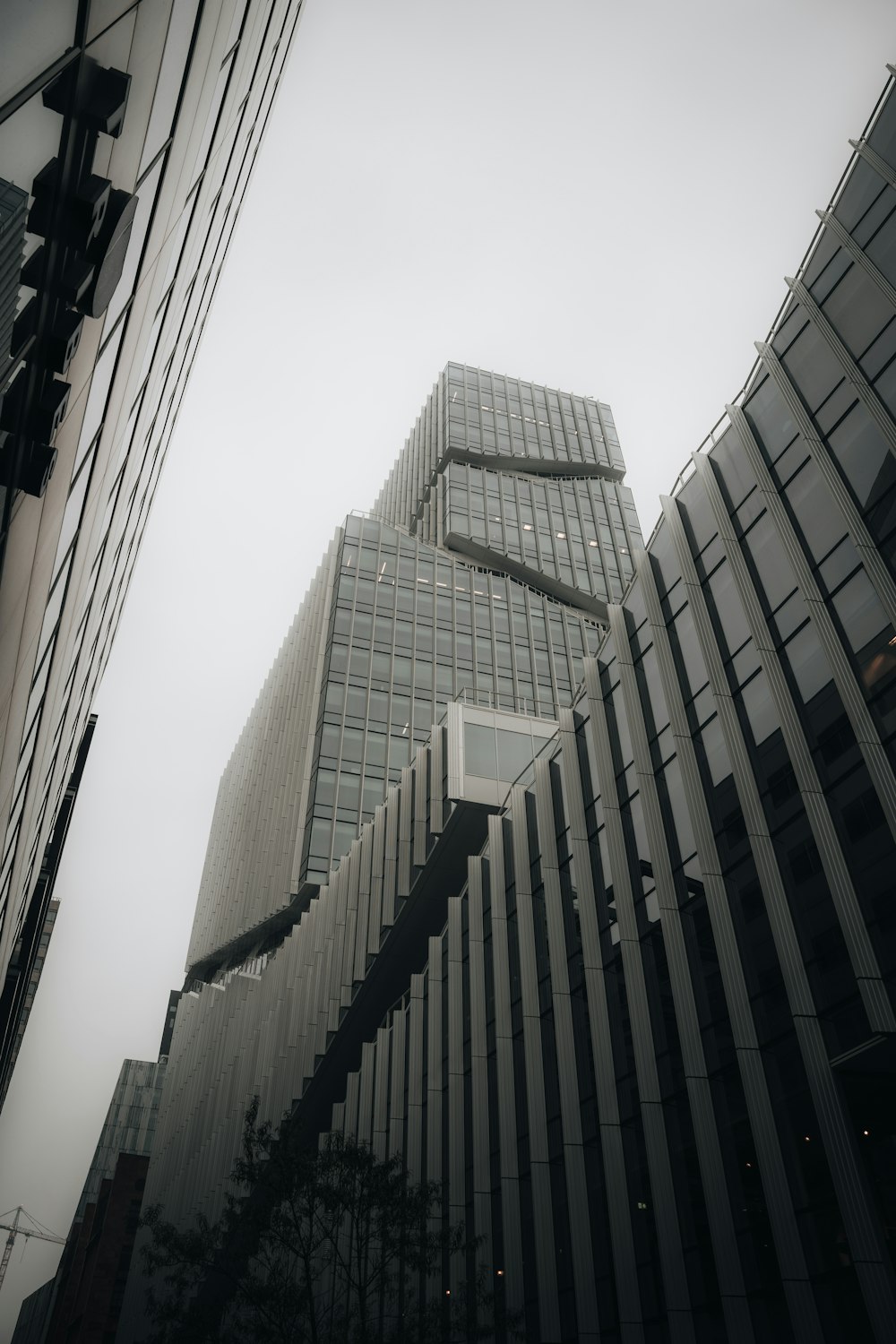 a very tall building sitting next to other tall buildings