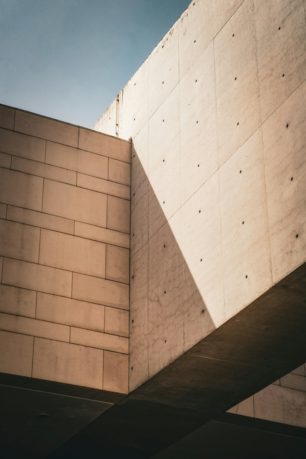 a building with a concrete wall and a sky background