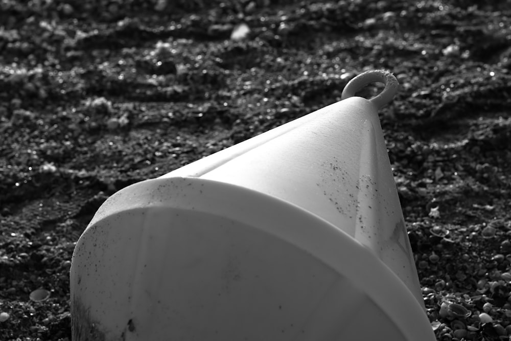 a white toilet sitting on top of a dirt field