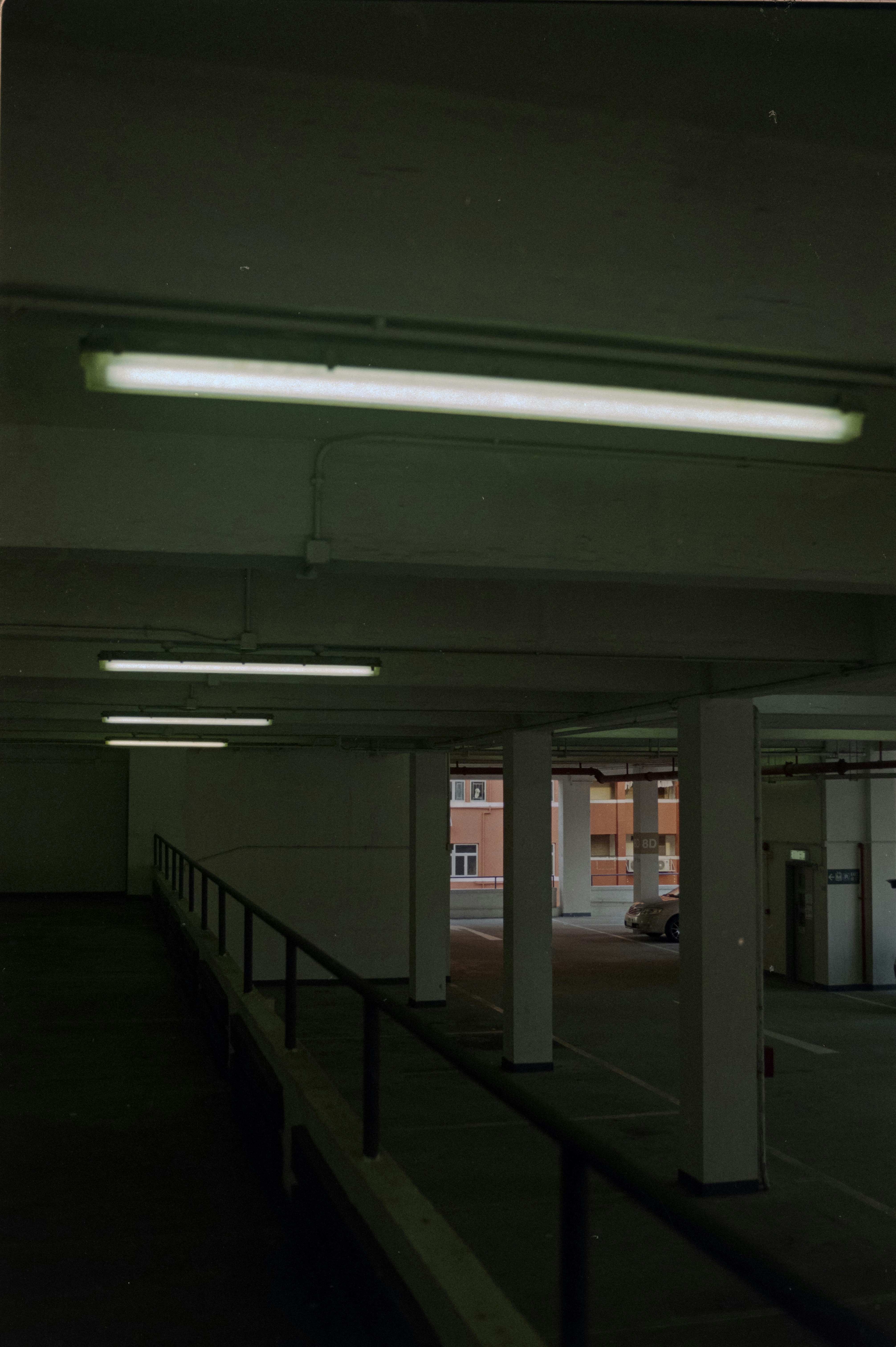 an empty parking garage with lights on the ceiling