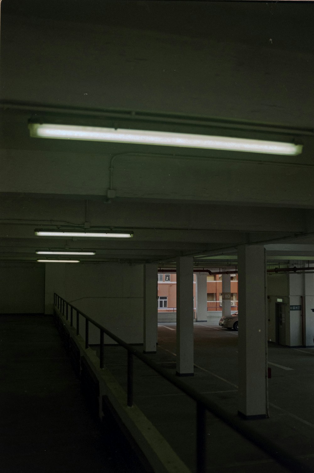 an empty parking garage with lights on the ceiling