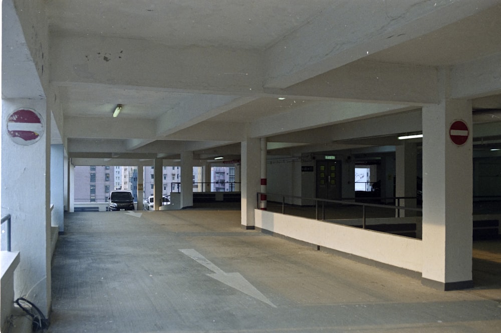 an empty parking garage with a car parked in it