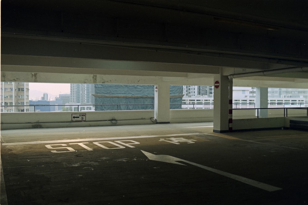 an empty parking garage with a view of the city