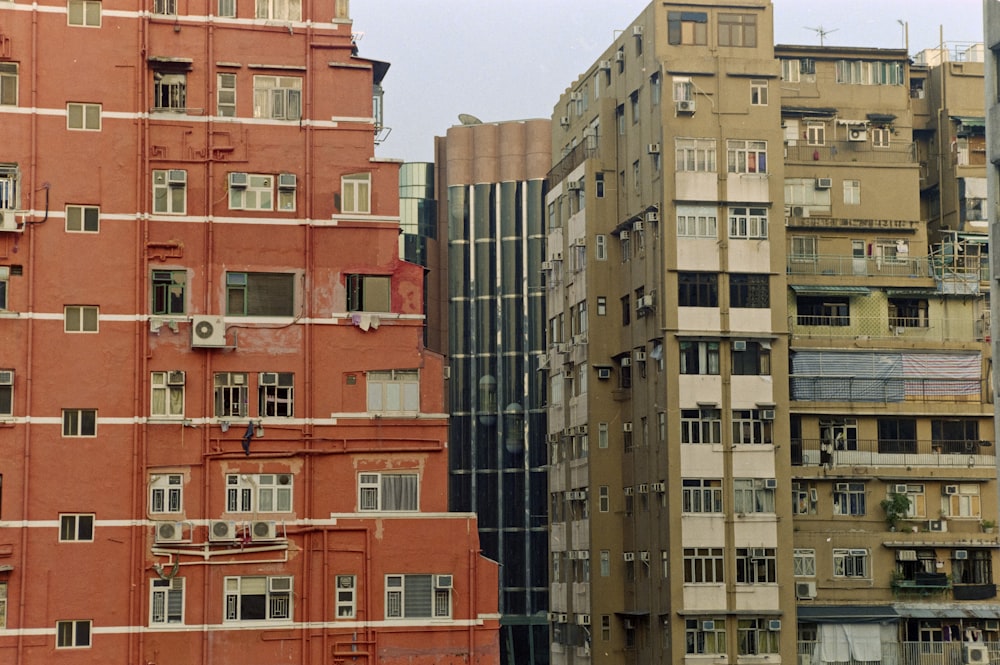 a tall building with lots of windows next to other buildings