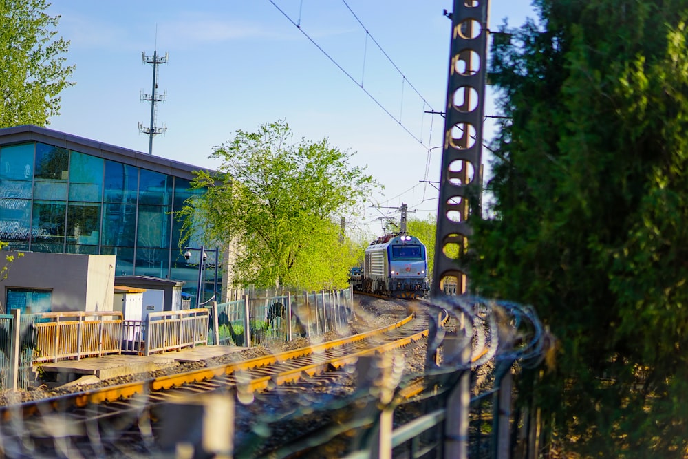 a train on a train track near a building