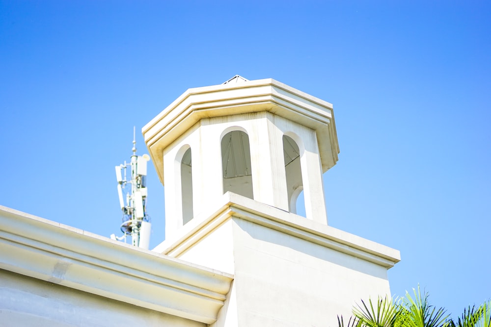 a clock tower on top of a white building