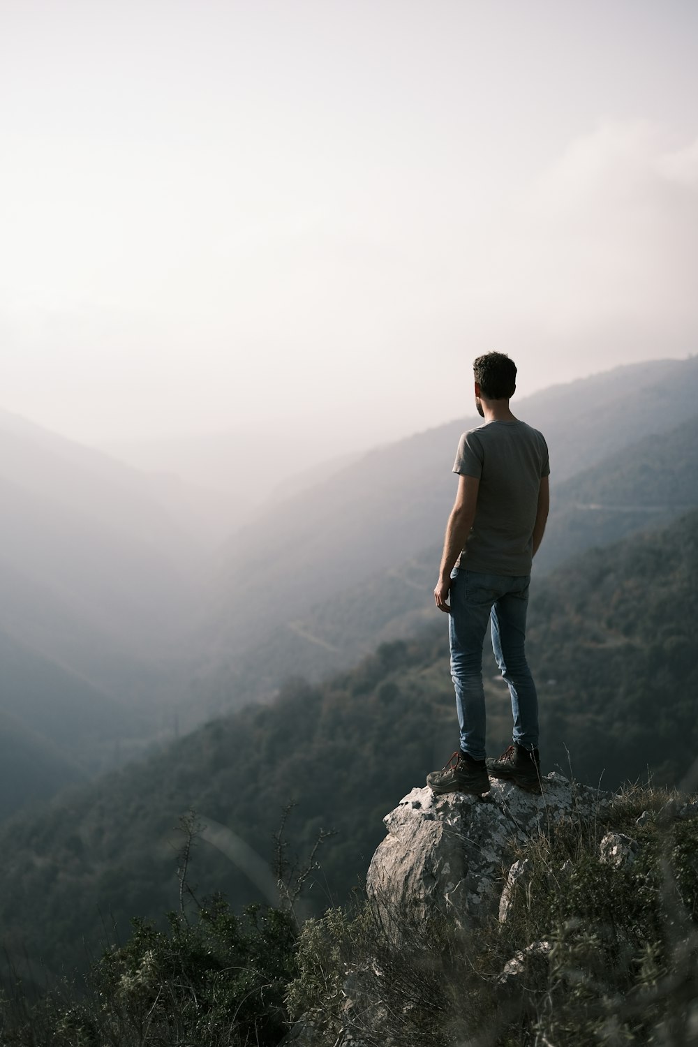 a man standing on top of a large rock