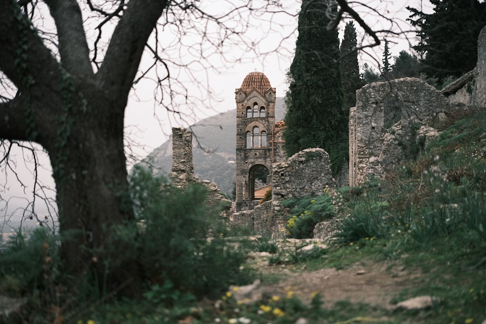 a very old building sitting on the side of a hill