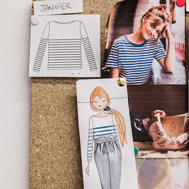 Close-up of rough sketches pinned to a board, showing the evolving ideas that shape elier’s identity.