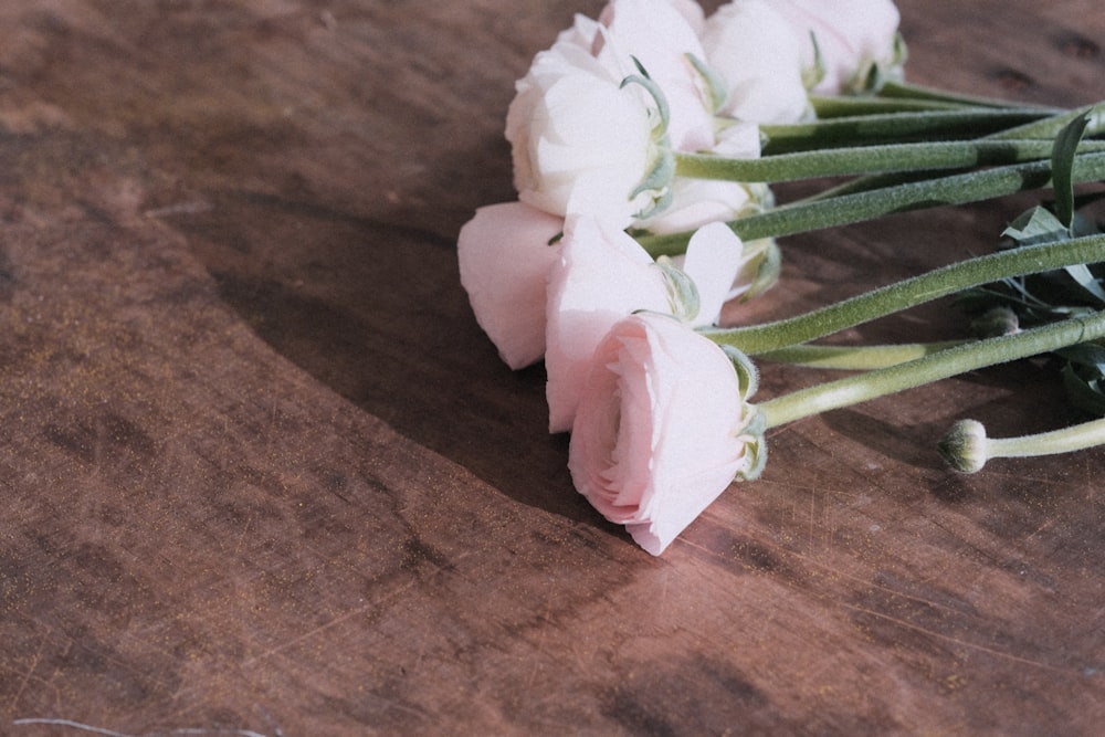 a bunch of flowers sitting on top of a wooden table