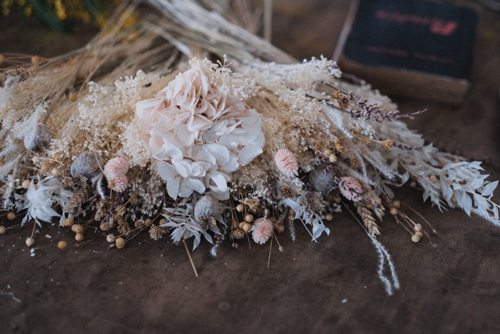 a bunch of dried flowers sitting on top of a table