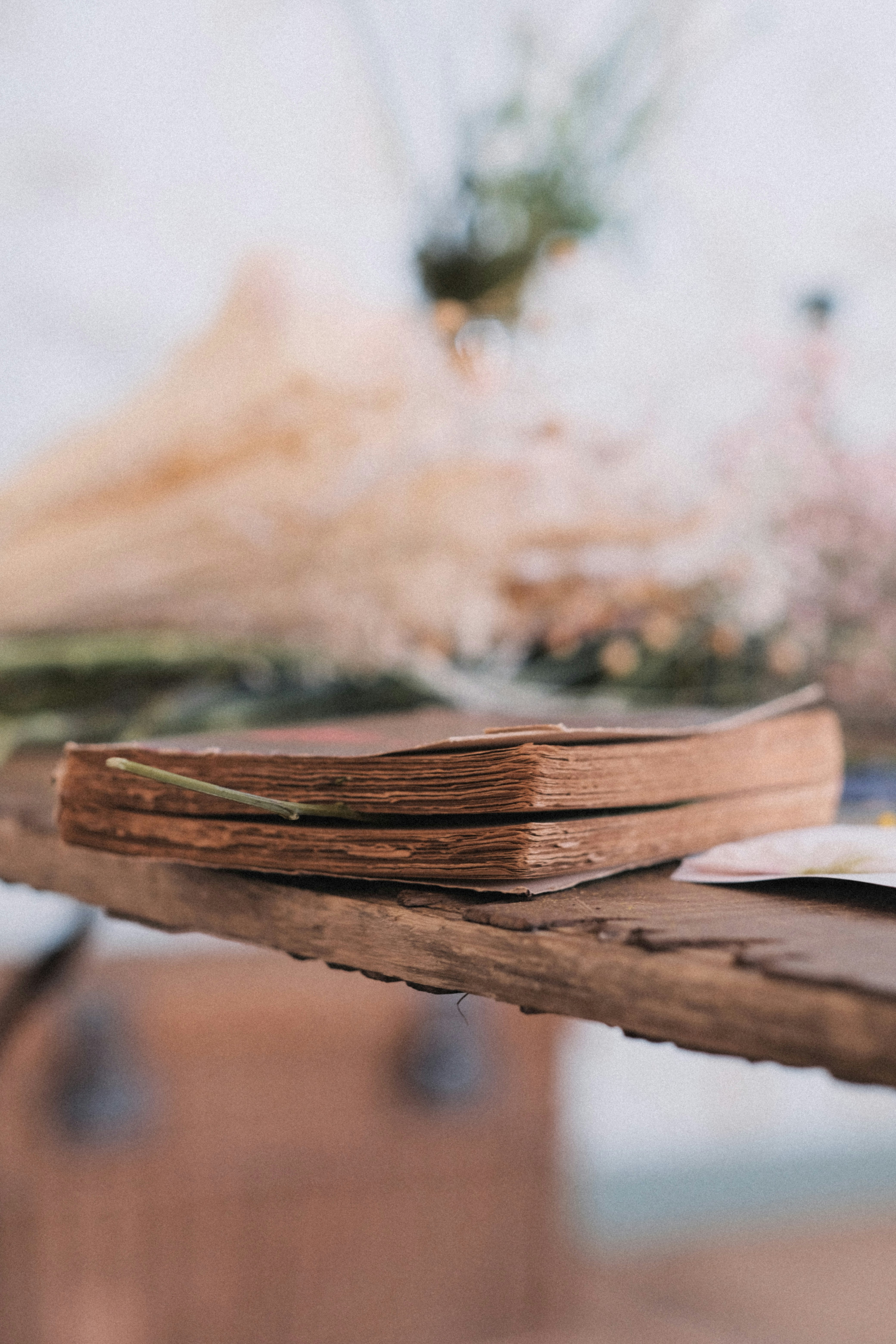 a stack of books sitting on top of a wooden table