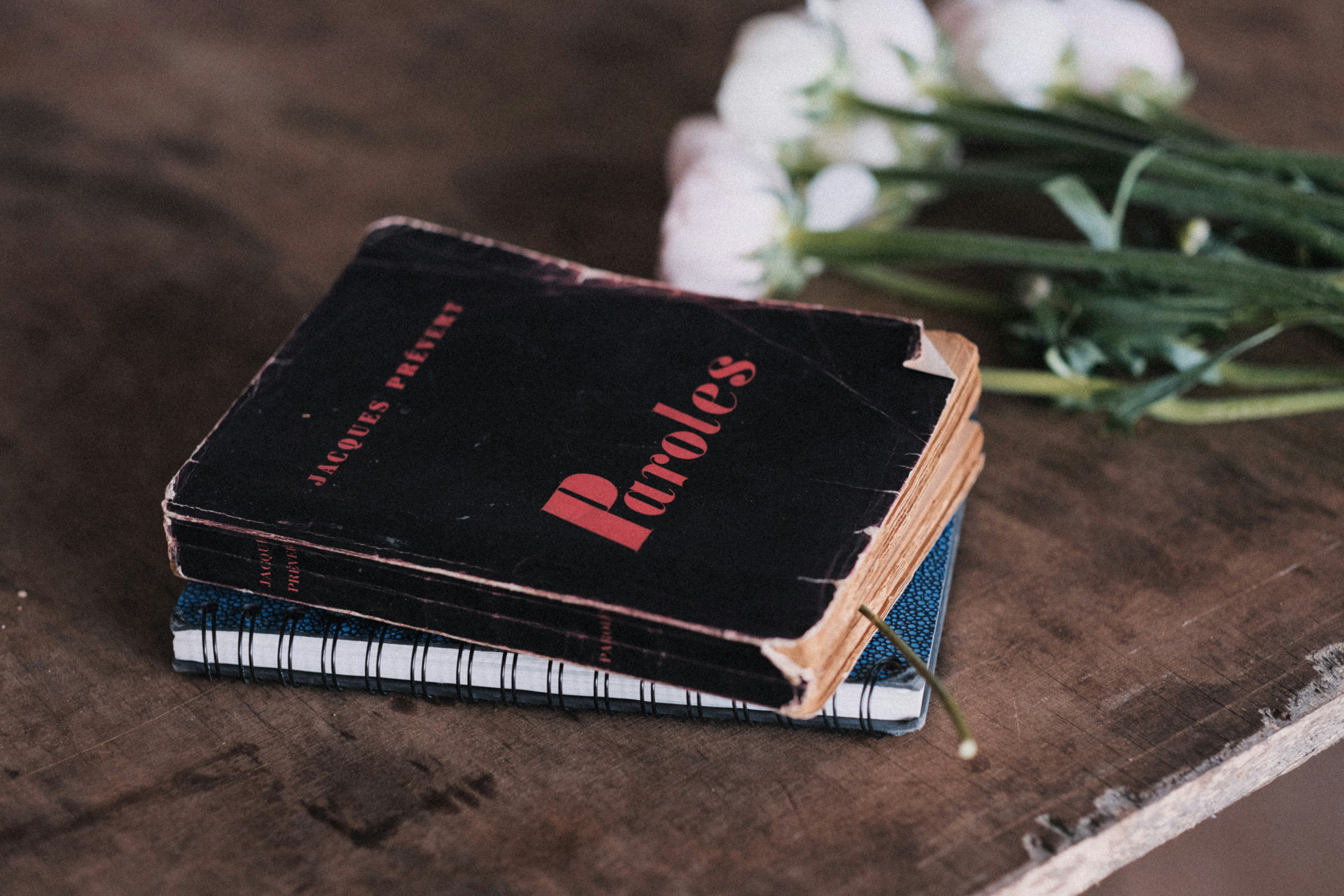 a stack of books sitting on top of a wooden table