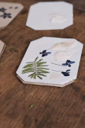 An assortment of colorful resin coasters arranged neatly on a wooden table.