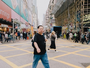 A busy city street with people walking to work in the morning