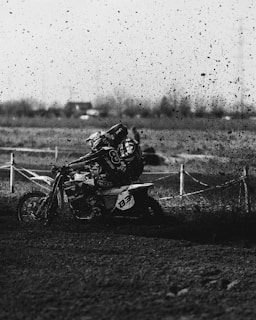 A dynamic shot capturing the intense focus of a rider navigating a sharp turn with mud splashing.