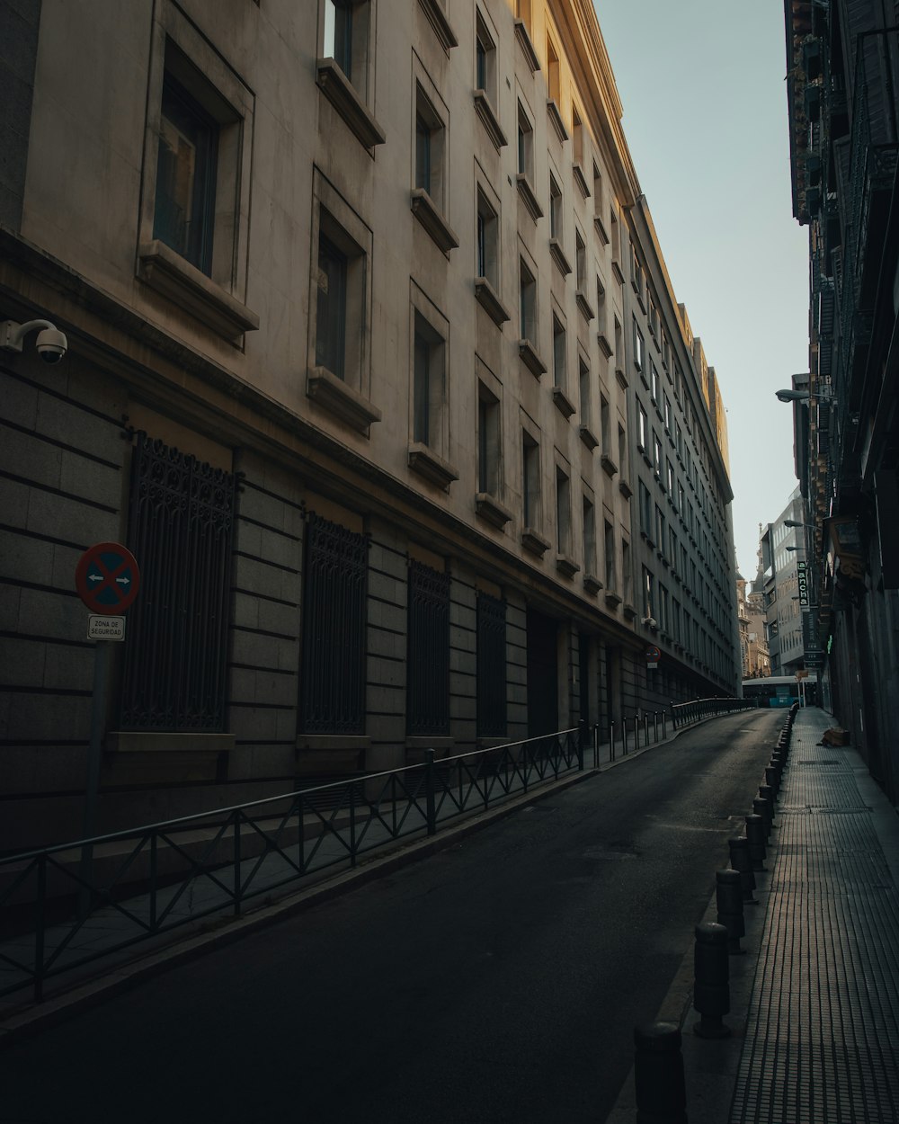 an empty street in a city with tall buildings