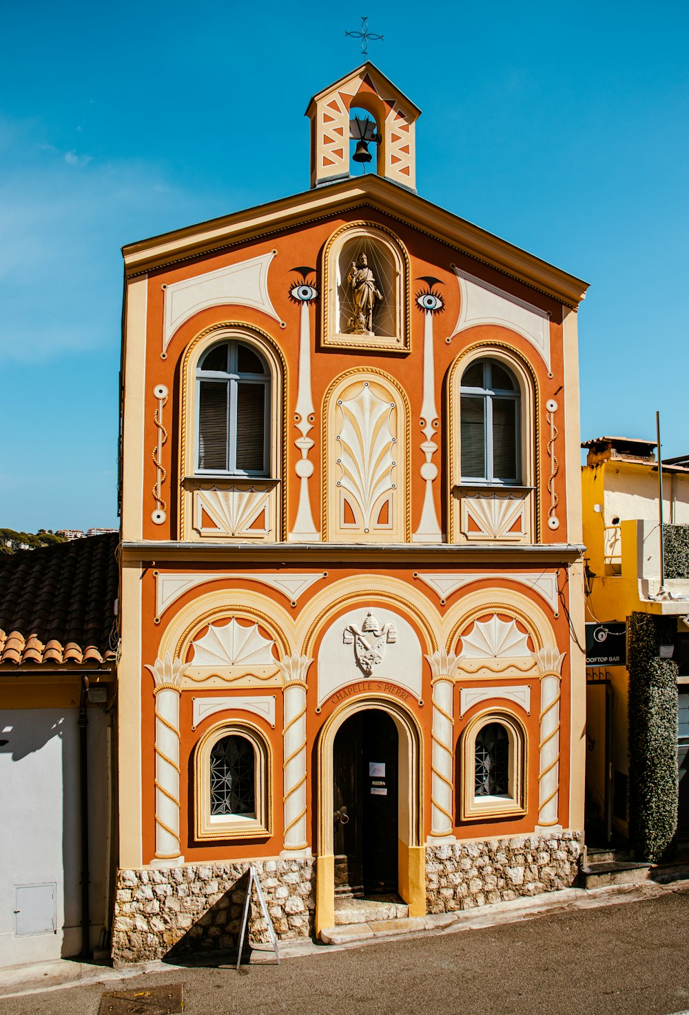 an orange and white building with a clock tower