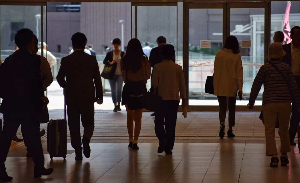 a group of people walking through a lobby