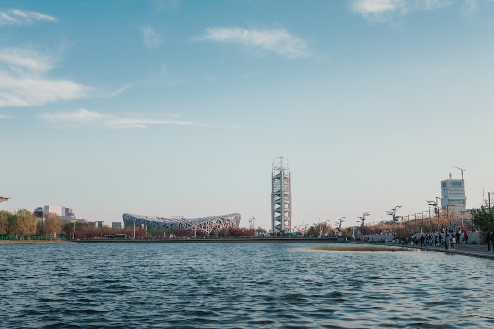 a body of water with a bridge in the background