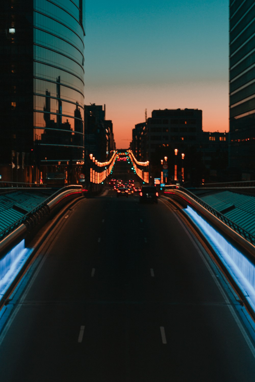 a city street at night with buildings and lights