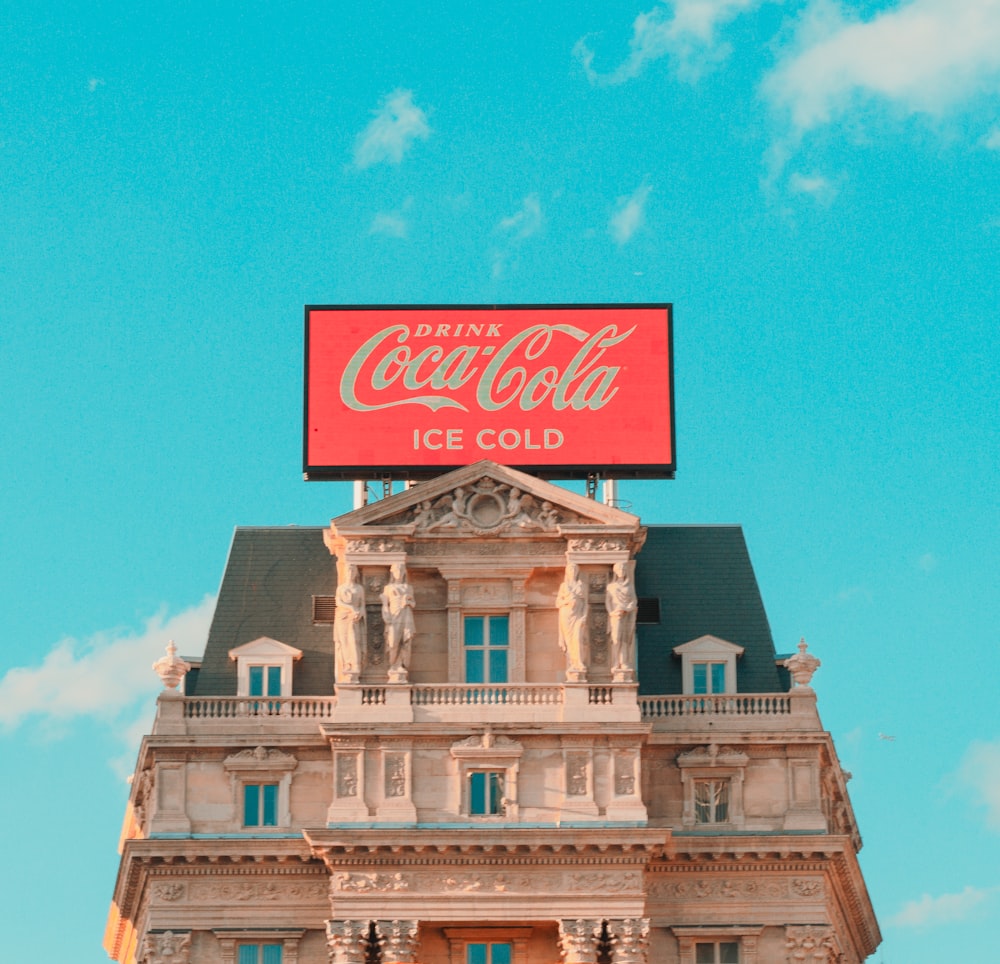 a large coca cola sign on top of a building