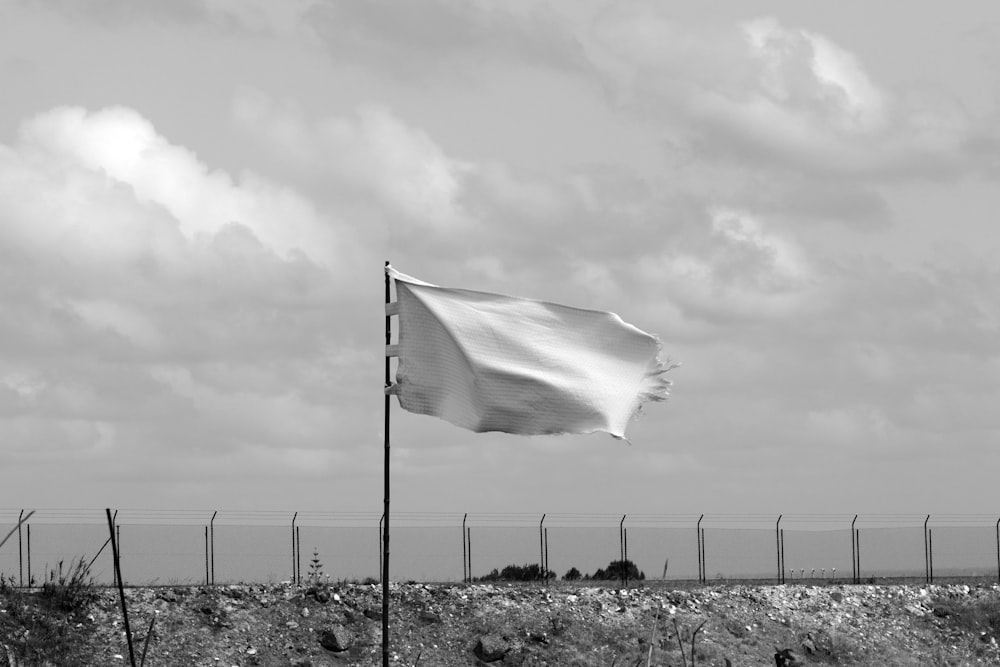 a large white flag flying in the wind