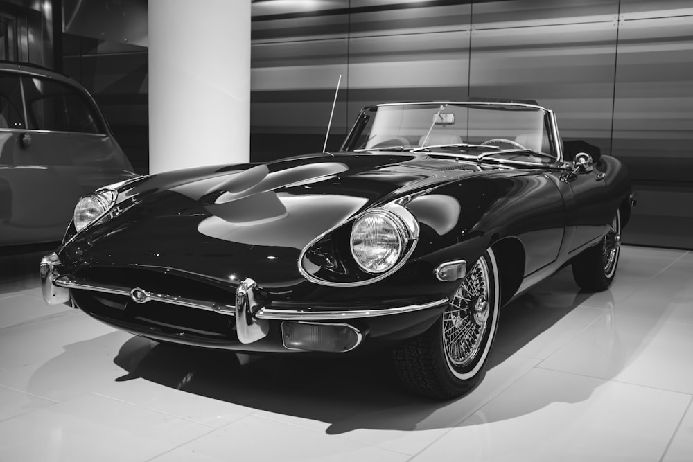 a black and white photo of a classic car