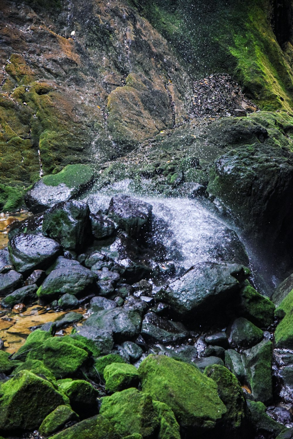a stream of water coming out of a cave