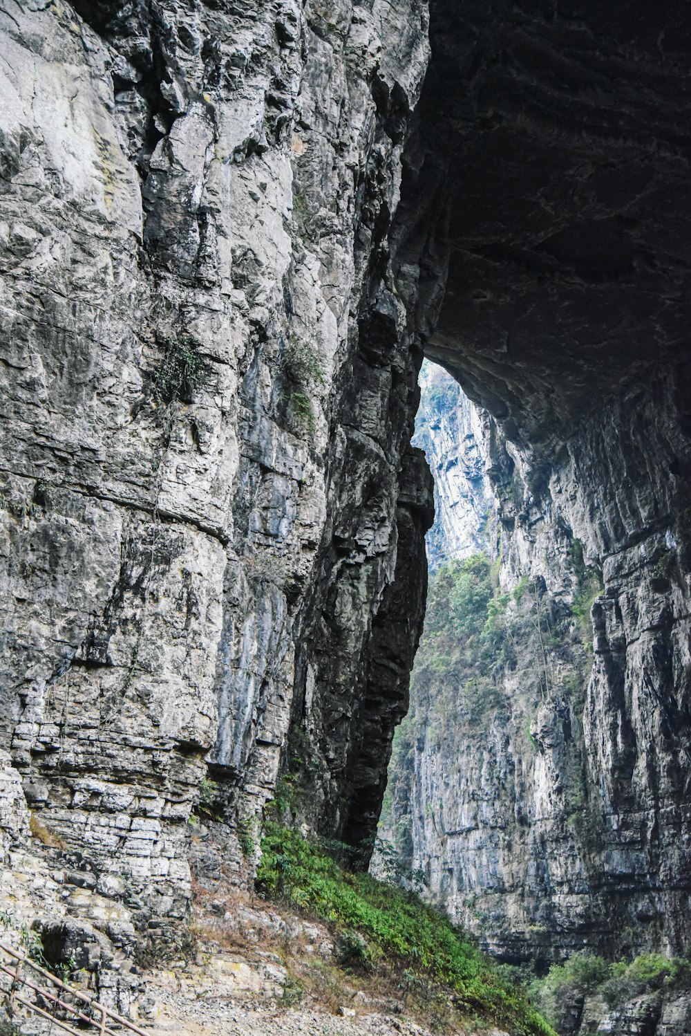 a man standing on the side of a cliff next to a river