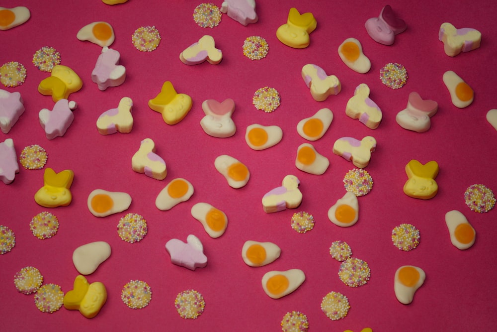 a pink table topped with lots of different types of candies