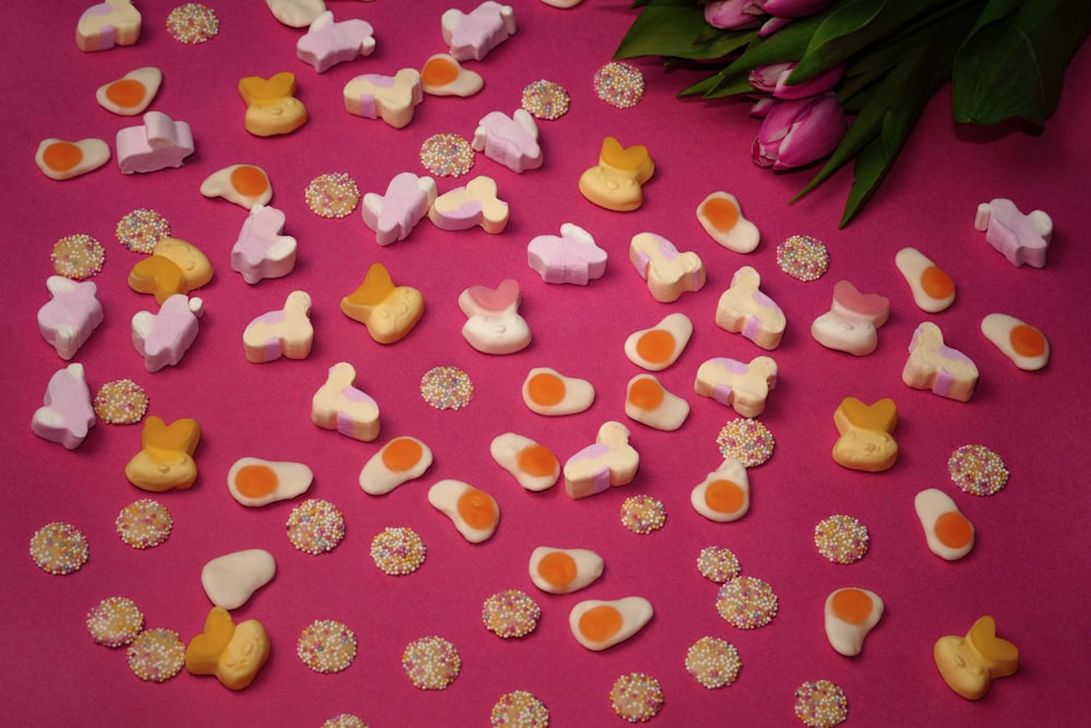 a pink table topped with lots of different types of candies