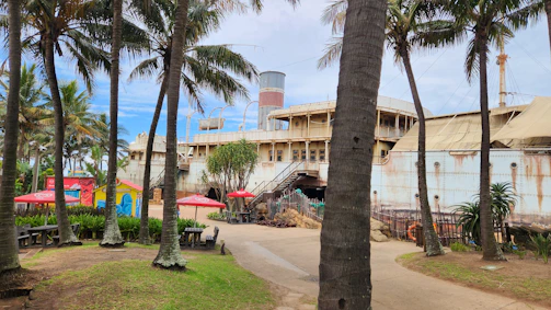 The ship anchored near a tropical island with palm trees.