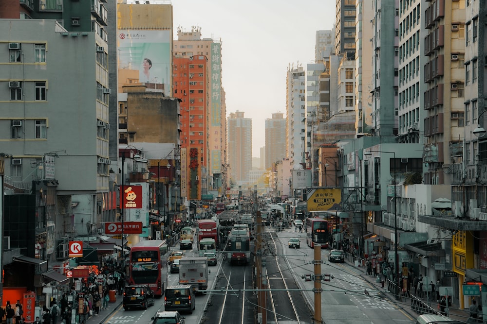 a city street filled with lots of traffic and tall buildings