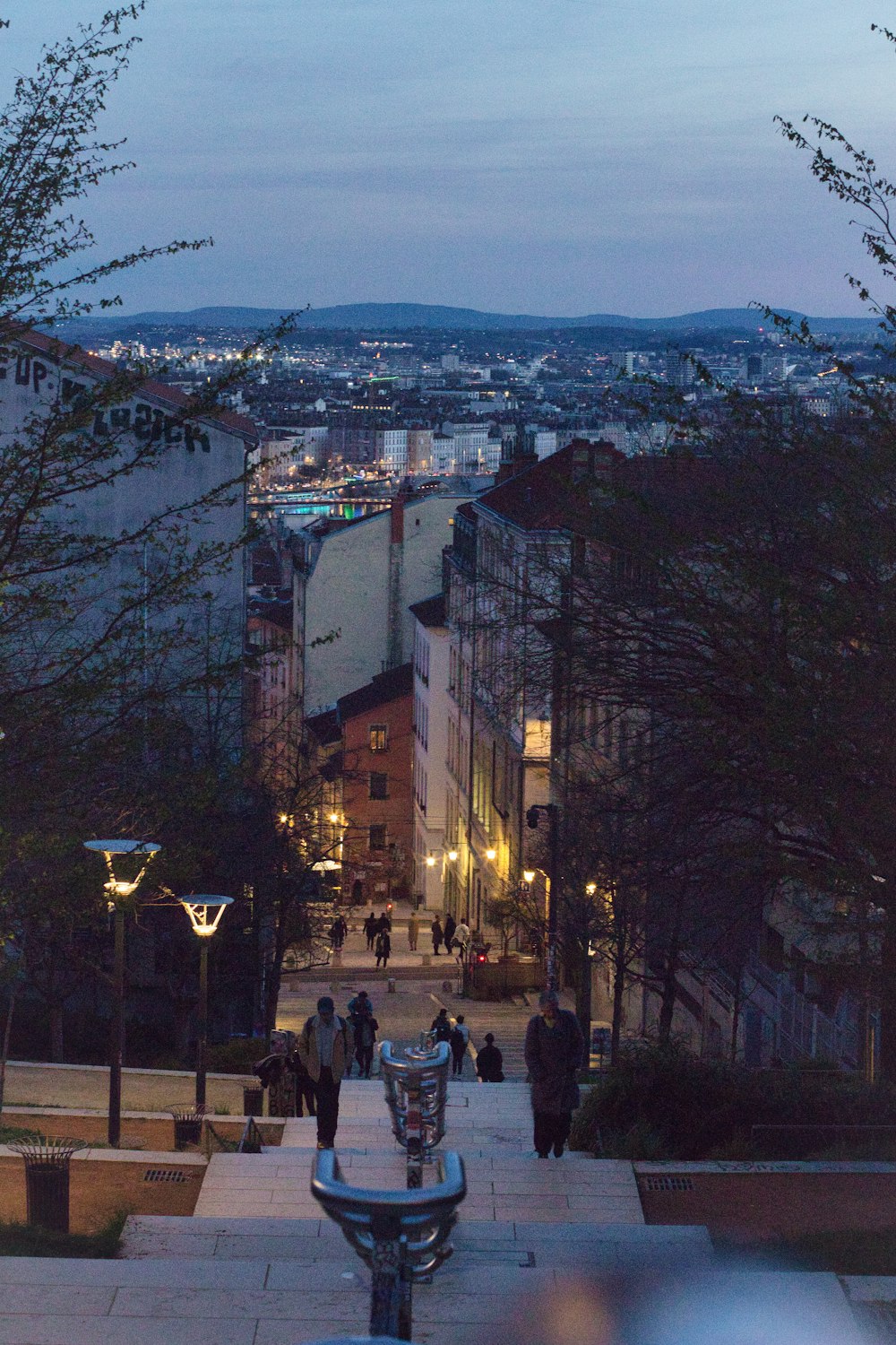 a view of a city at night from the top of a hill