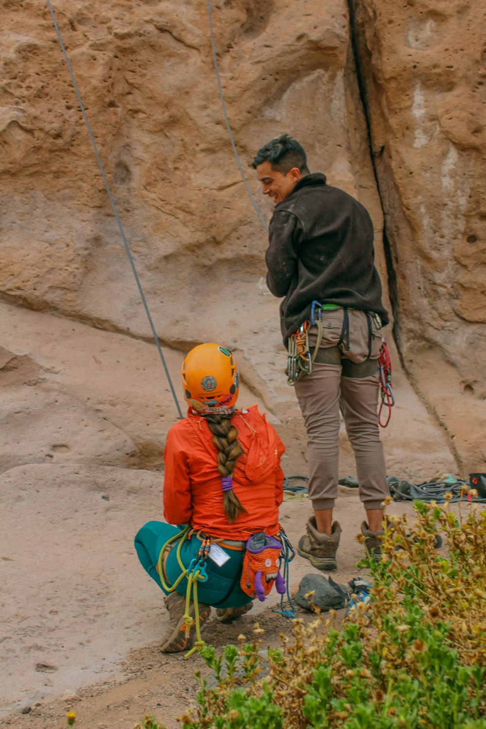 a man standing next to a woman on top of a cliff