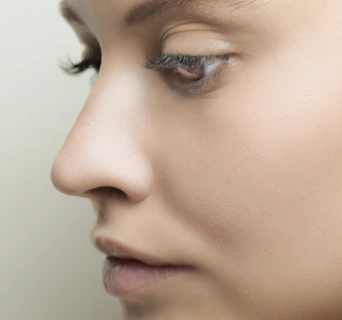 a close up of a woman's face with her eyes closed