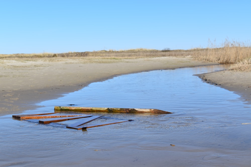 a small stream running through a sandy beach