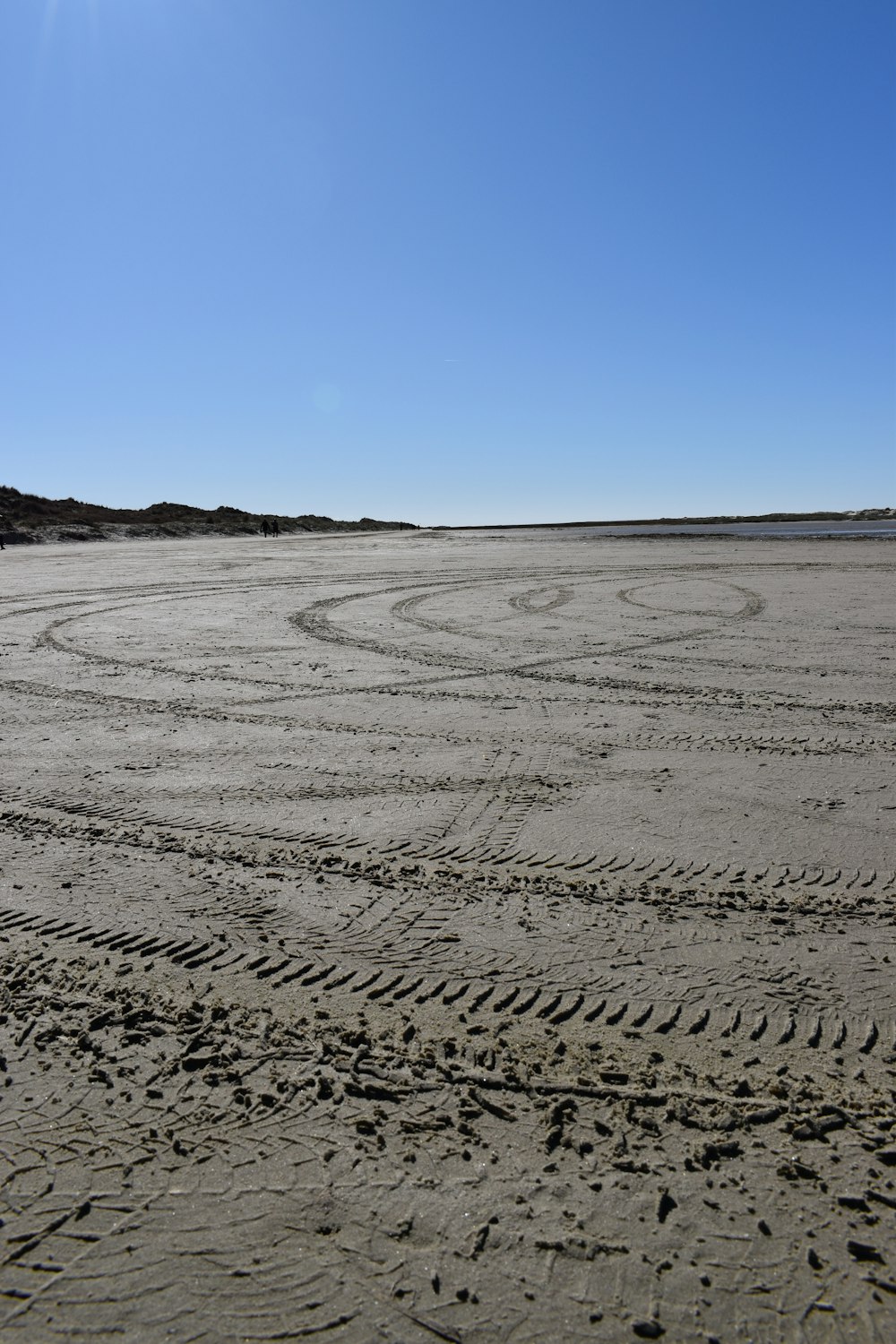 a tire track in the sand on a beach