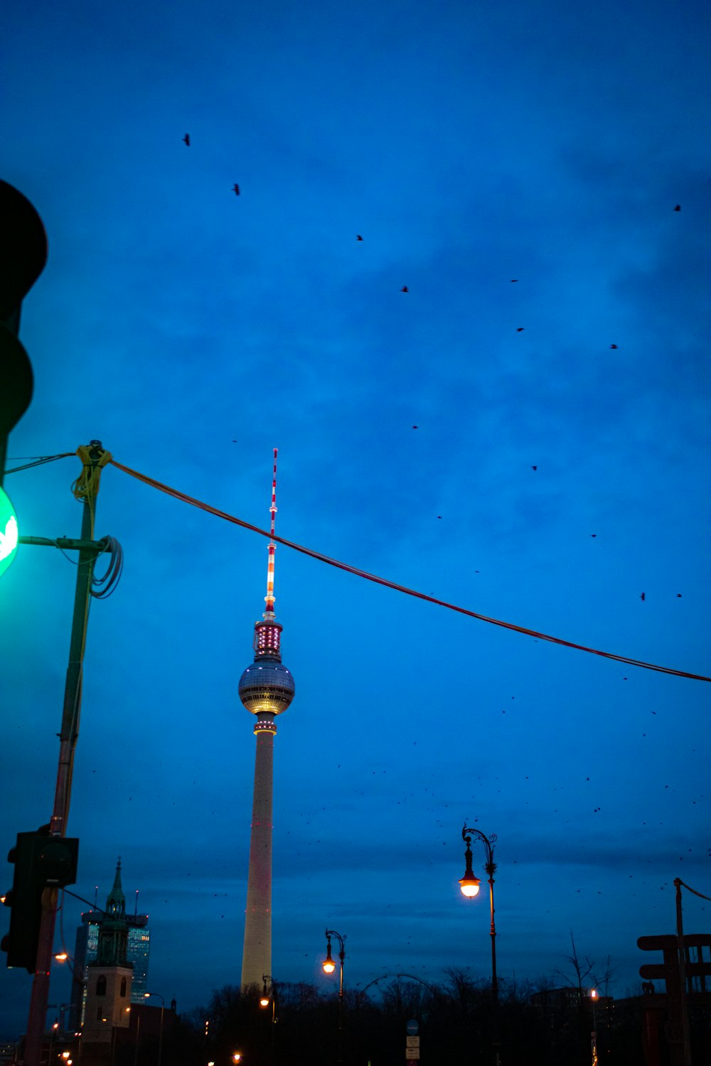 a traffic light with a tower in the background