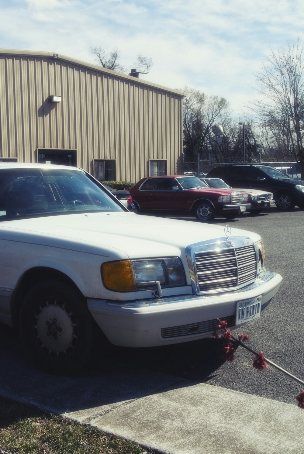 a white mercedes parked in a parking lot