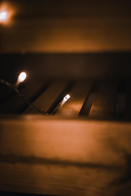 A cozy corner of votra with flickering candlelight and warm wooden textures.